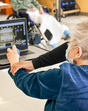 Therapist assisting resident at Riverdale Center with RESTORE therapy